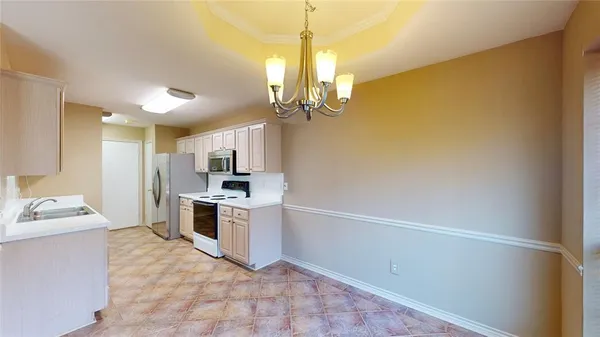 a kitchen with a sink and stainless steel appliances