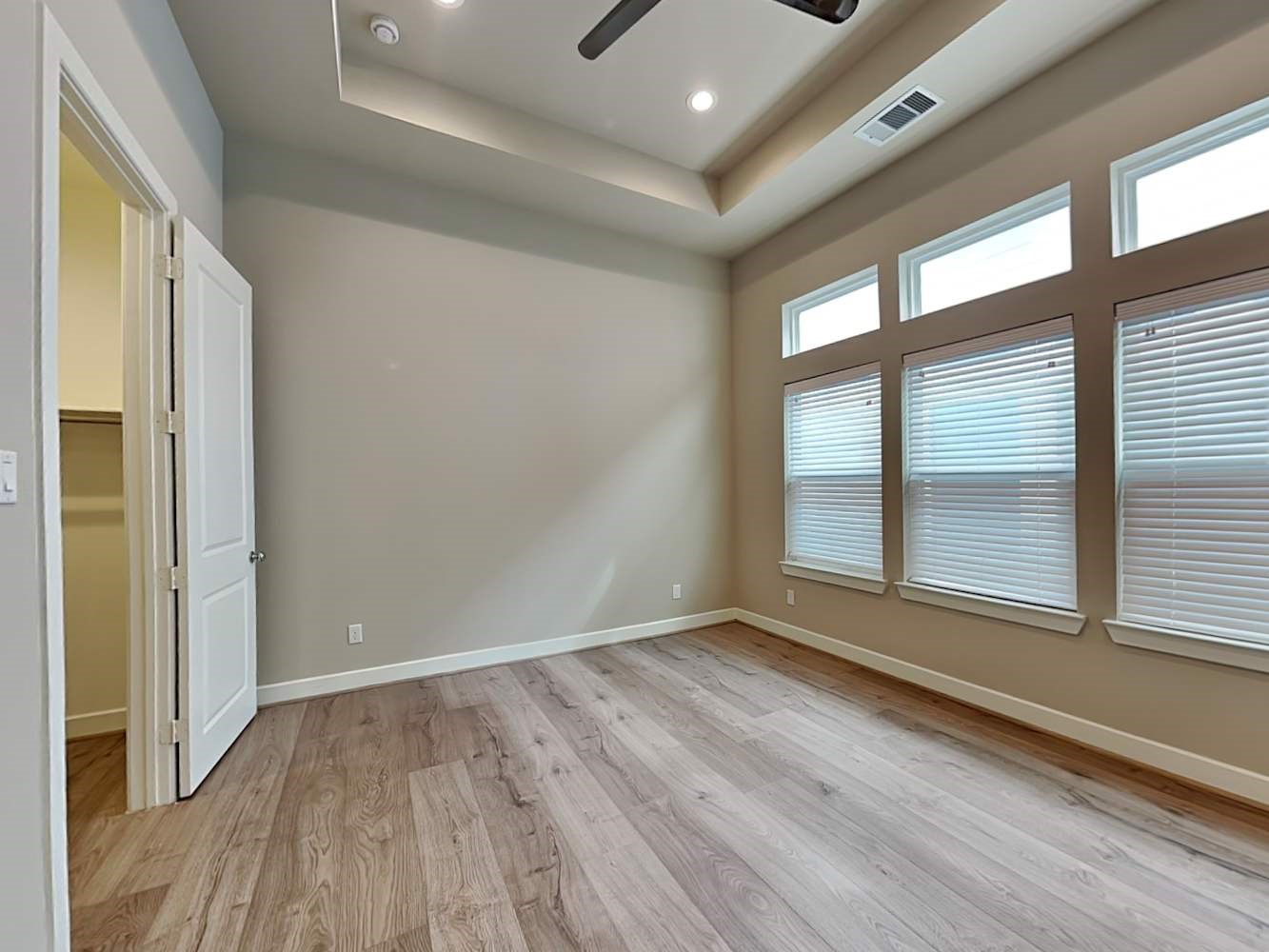 6347 Paddington Bend Drive Houston, TX 77008 - Photo 6 of 14 a view of an empty room with wooden floor and a window