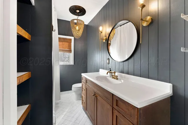 a bathroom with a sink vanity and a mirror