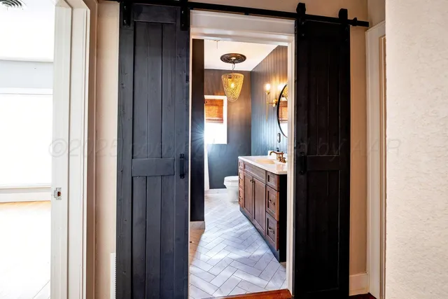 a view of a bathroom from a hallway
