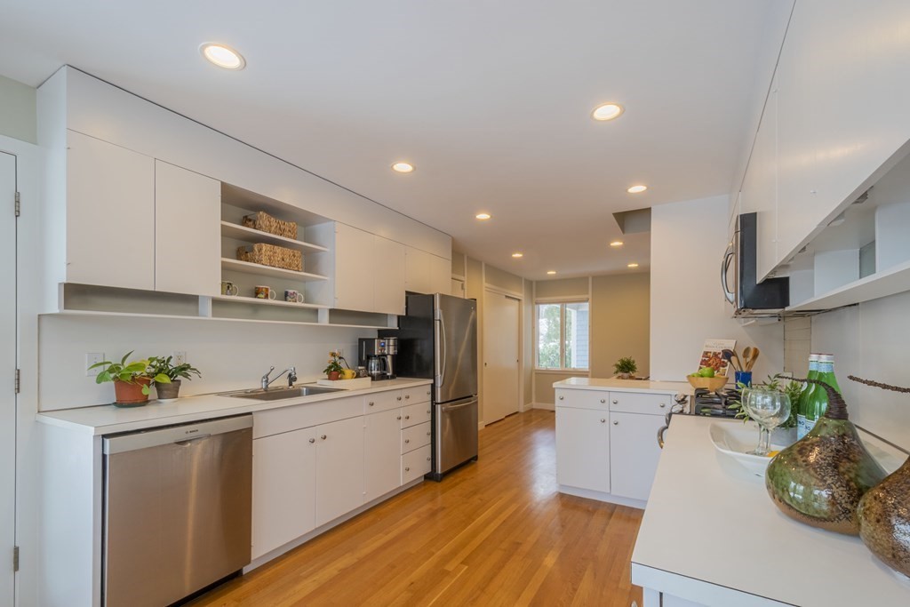 43 Baskin Road Lexington, MA 02421 - Photo 15 of 42 a kitchen with stainless steel appliances granite countertop a refrigerator sink and cabinets