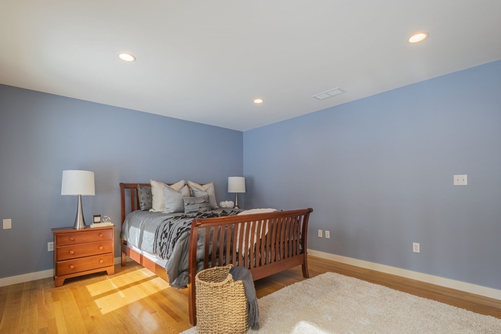 43 Baskin Road Lexington, MA 02421 - Photo 19 of 42 a bedroom with a bed and a lamp
