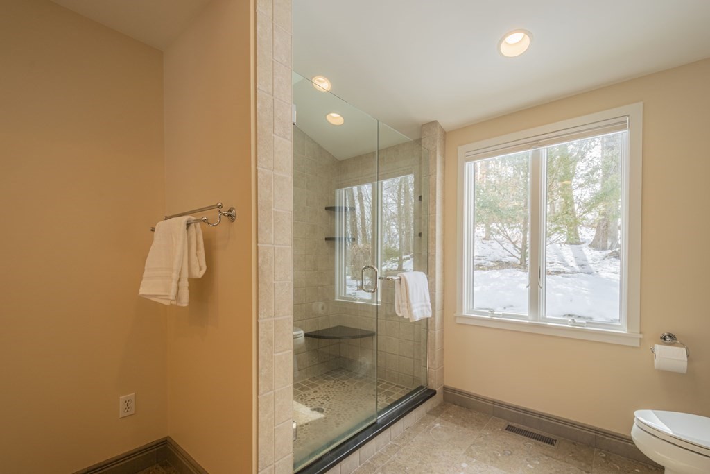 43 Baskin Road Lexington, MA 02421 - Photo 22 of 42 a bathroom with a glass shower door