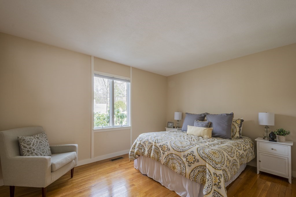 43 Baskin Road Lexington, MA 02421 - Photo 23 of 42 a bedroom with a bed and a couch