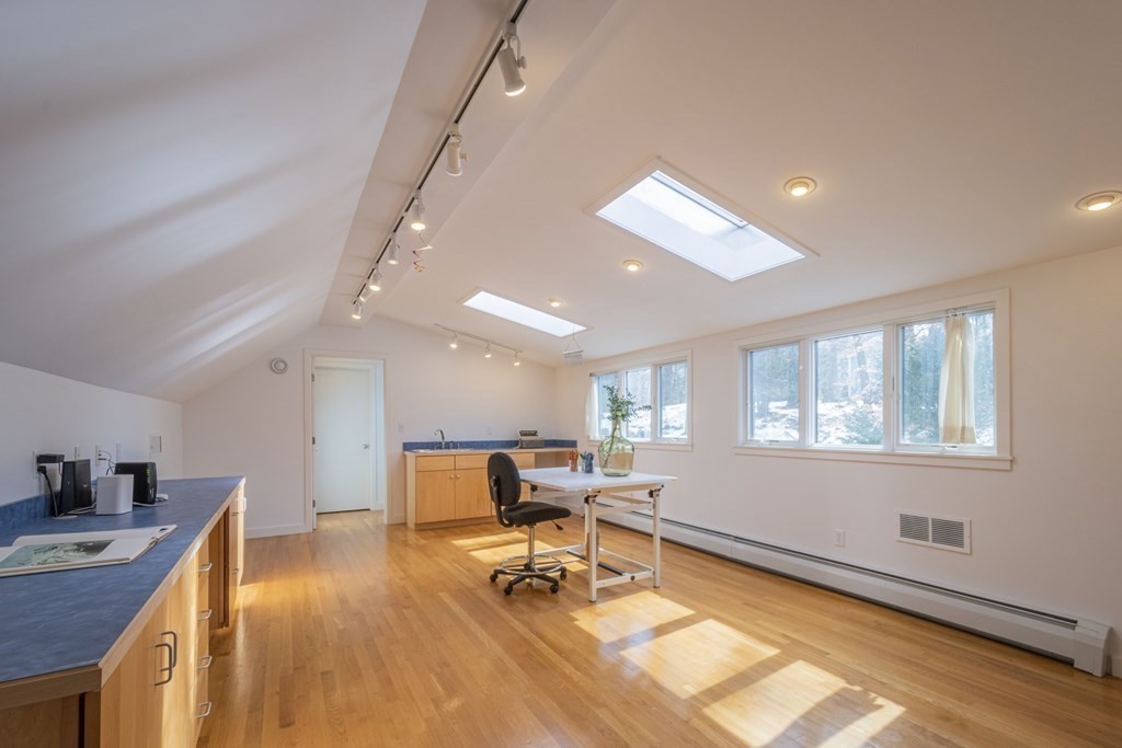 43 Baskin Road Lexington, MA 02421 - Photo 27 of 42 a view of a room with wooden floor and furniture