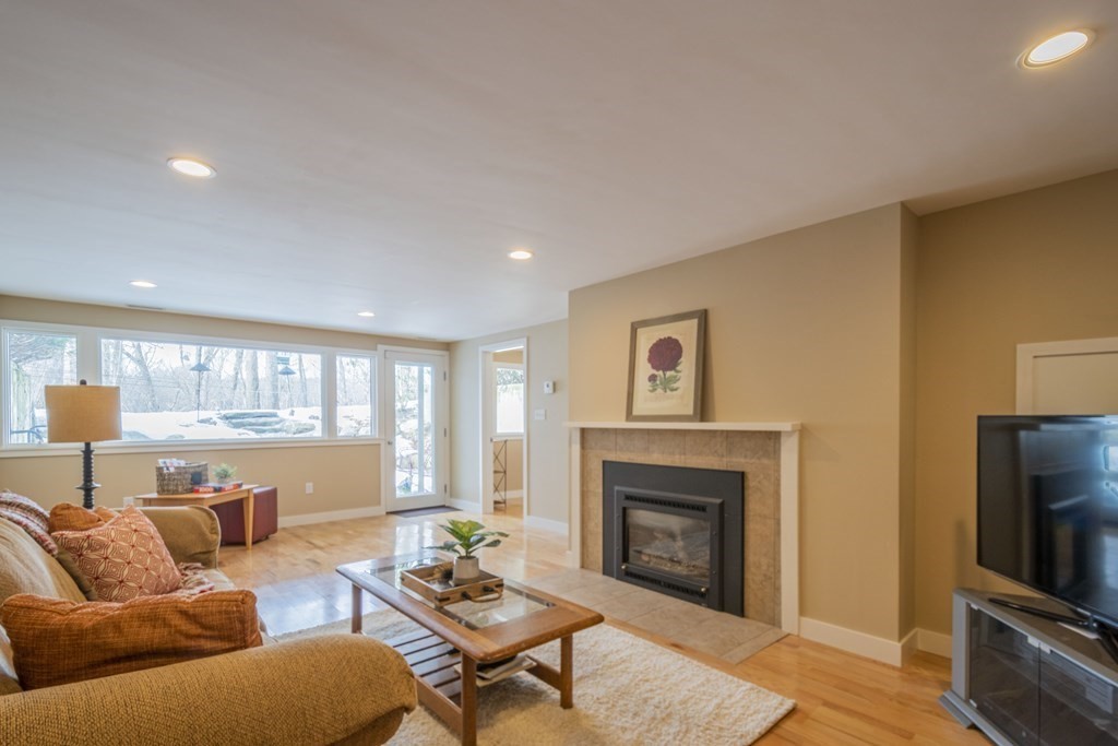 43 Baskin Road Lexington, MA 02421 - Photo 36 of 42 a living room with furniture flat screen tv and a fireplace