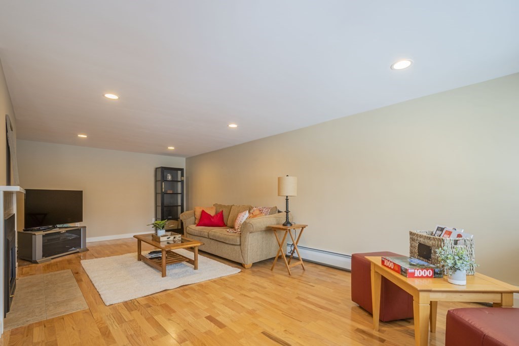 43 Baskin Road Lexington, MA 02421 - Photo 38 of 42 a living room with furniture and a flat screen tv