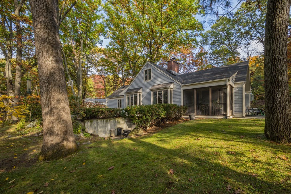 43 Baskin Road Lexington, MA 02421 - Photo 42 of 42 a front view of a house with a yard table and chairs