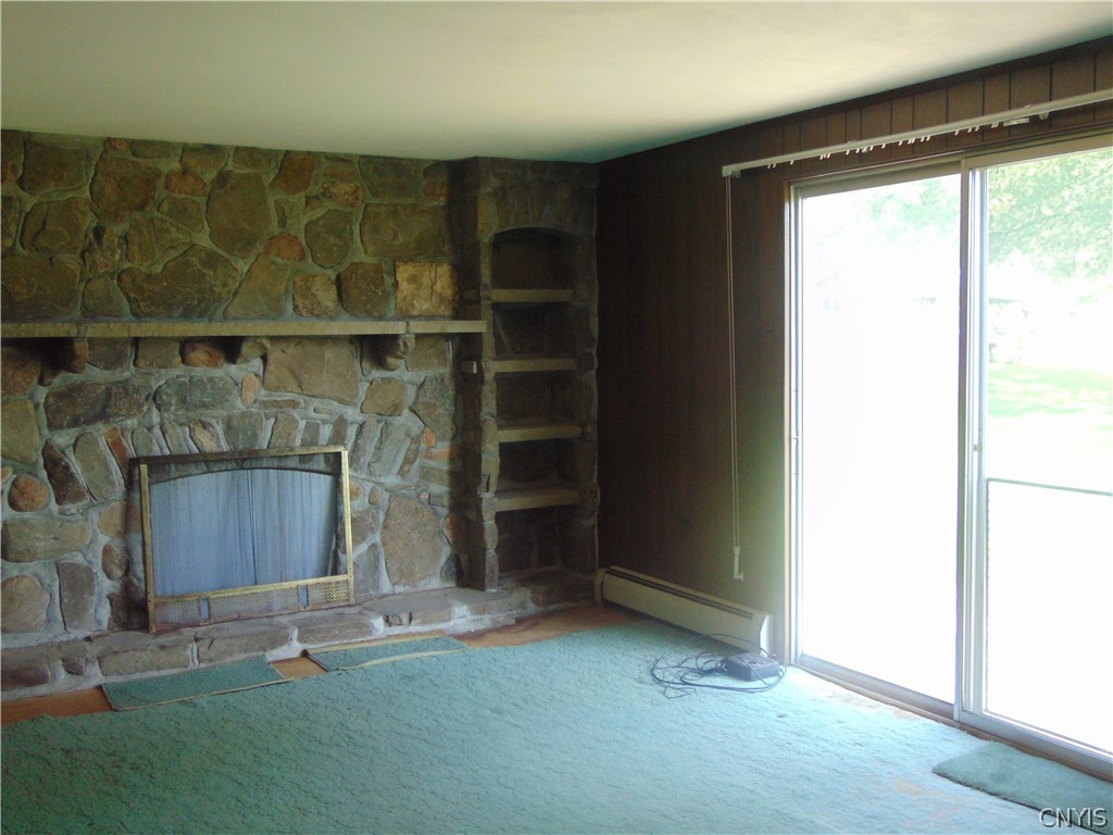 4800 Health Camp Road Homer, NY 13045 - Photo 19 of 40 Family room or living room with wood fireplace wit