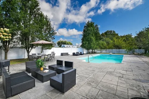 a view of backyard with outdoor seating and green space