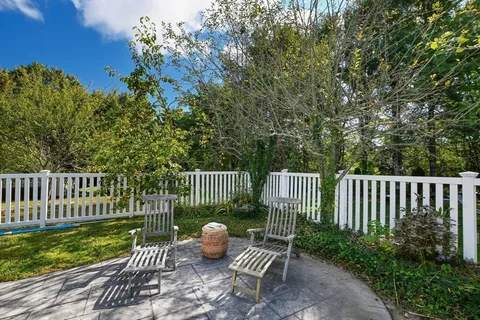 a view of a deck with a bench and a yard