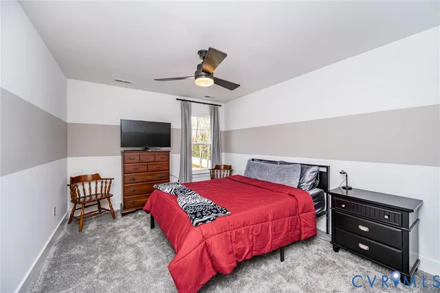 a bedroom with a bed and flat screen tv