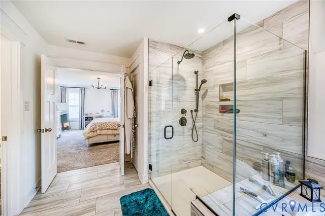 a bathroom with a glass shower door and a glass door shower