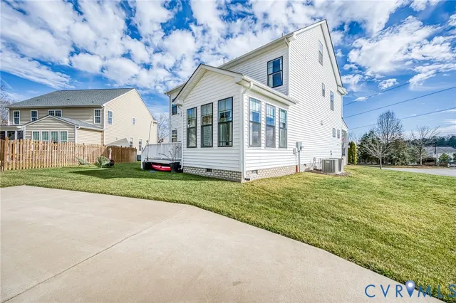a front view of a house with a yard and road