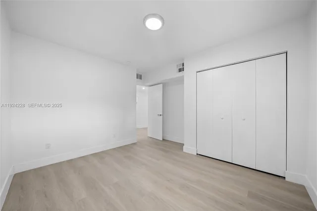 a view of kitchen with kitchen island and sink