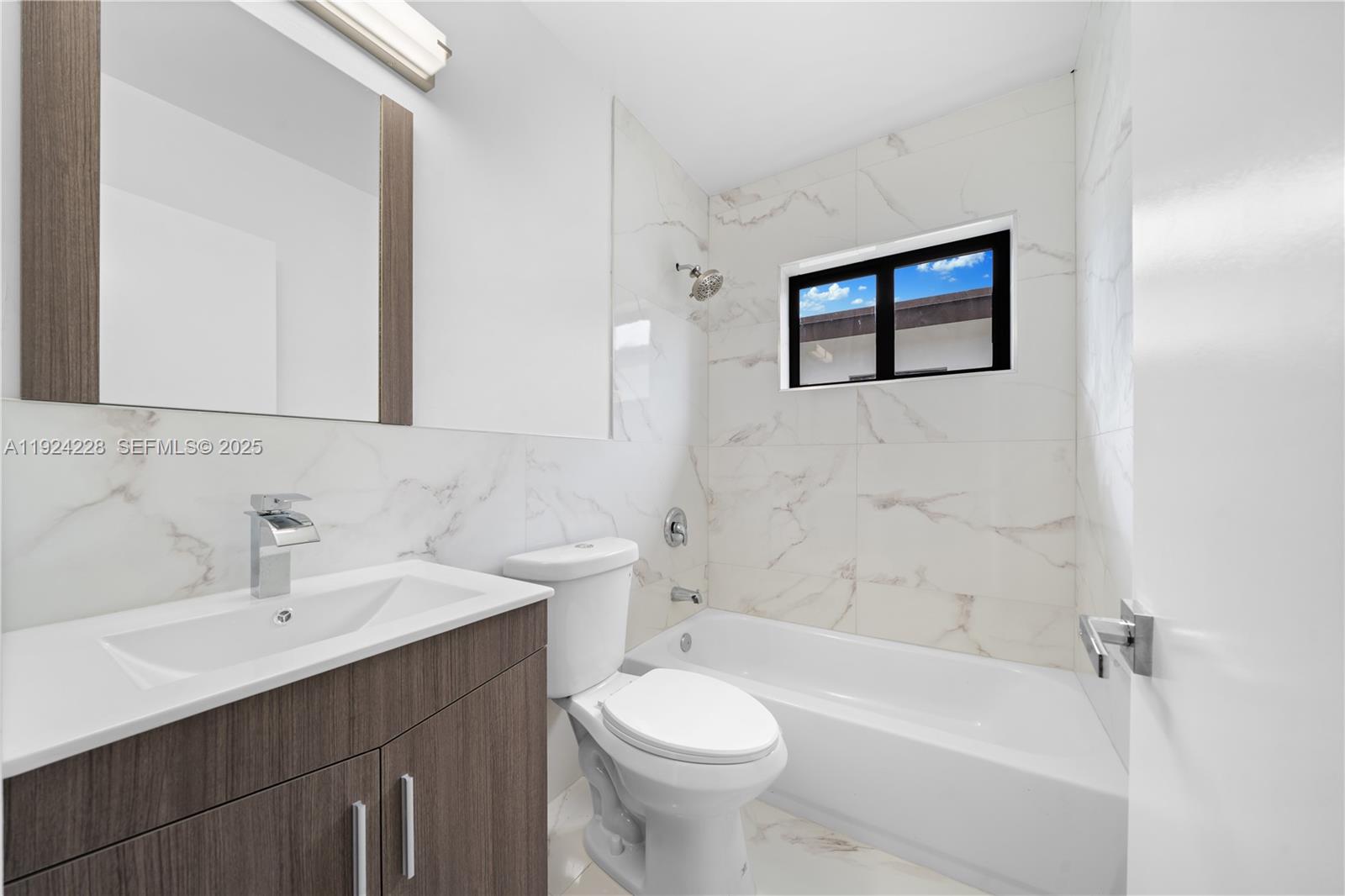 2983 Northwest 1st Street Pompano Beach, FL 33069 - Photo 23 of 28 a bathroom with a sink toilet and a bathtub