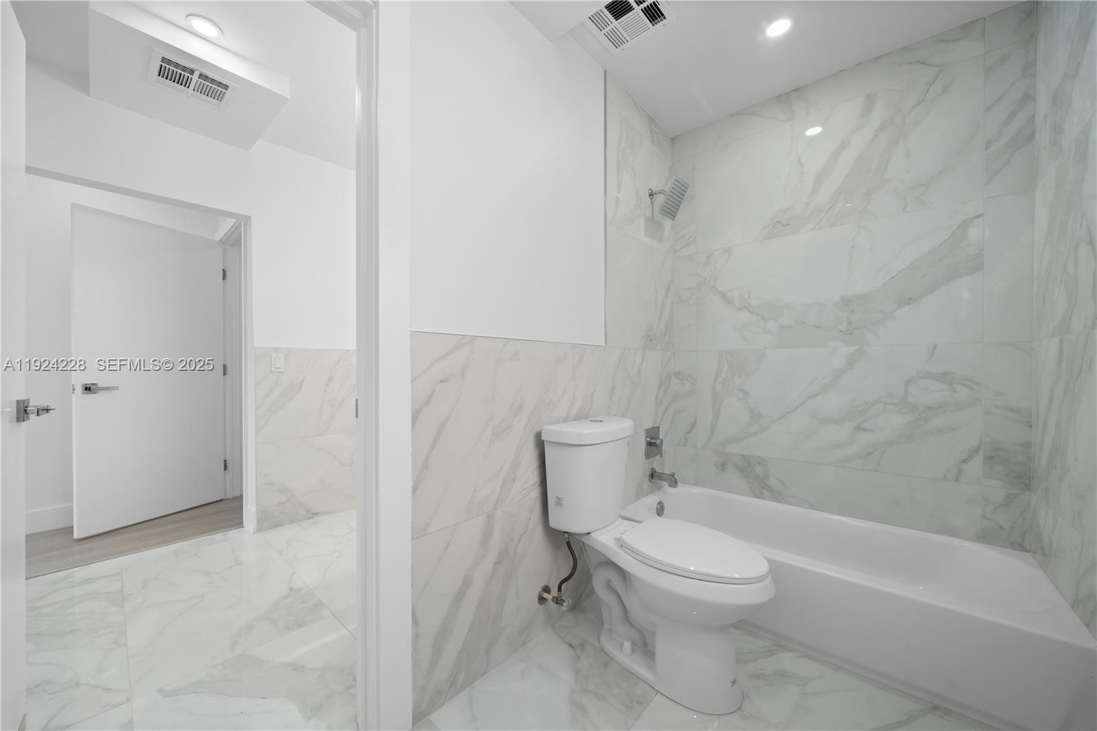 2983 Northwest 1st Street Pompano Beach, FL 33069 - Photo 26 of 28 a bathroom with a toilet and a shower