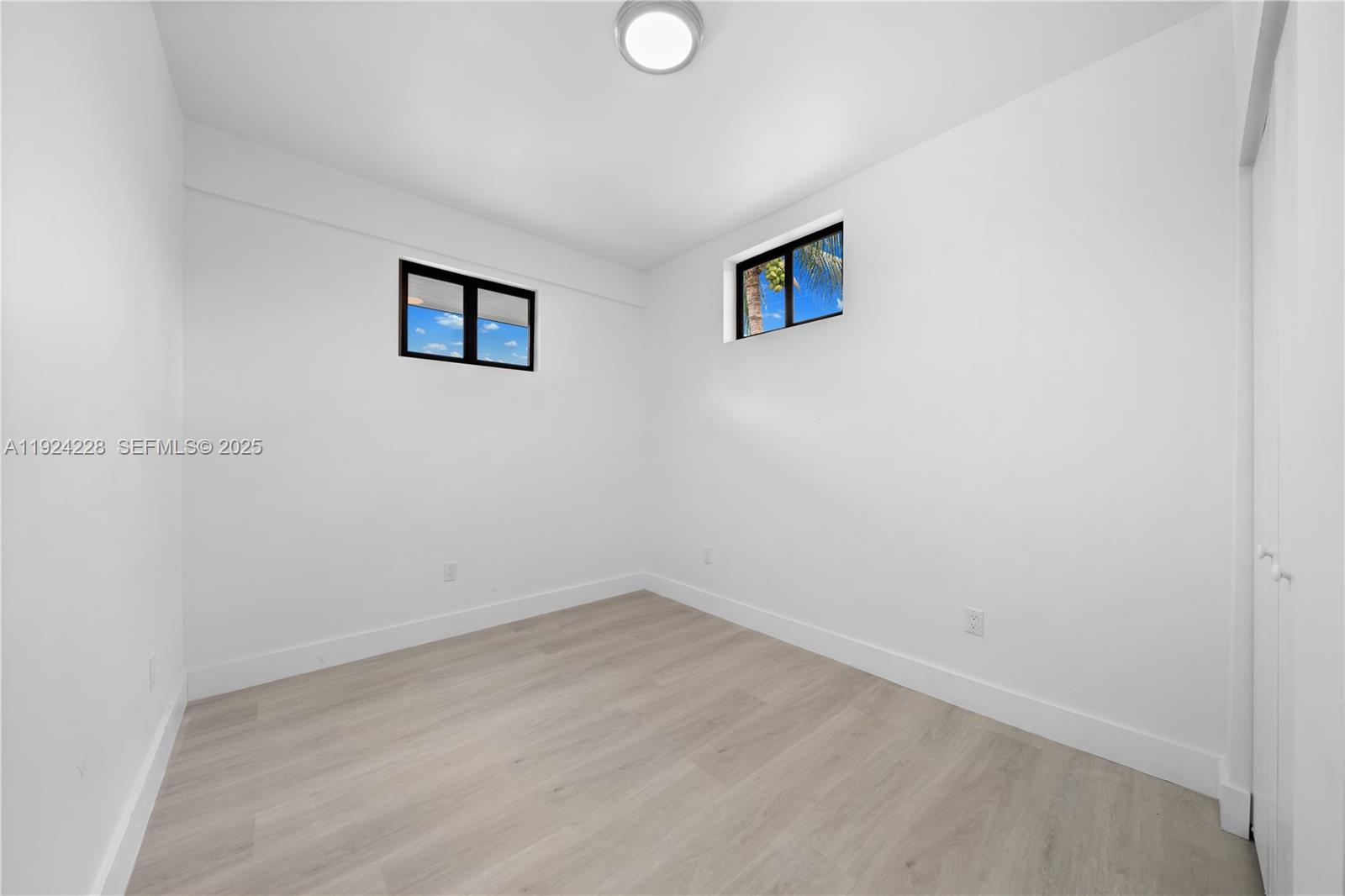 2983 Northwest 1st Street Pompano Beach, FL 33069 - Photo 4 of 28 an empty room with windows