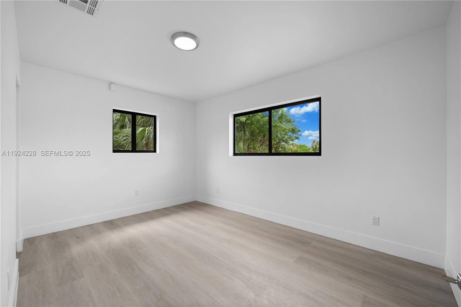 2983 Northwest 1st Street Pompano Beach, FL 33069 - Photo 6 of 28 an empty room with windows