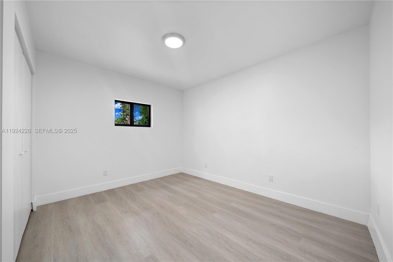 2983 Northwest 1st Street Pompano Beach, FL 33069 - Photo 7 of 28 a view of a room with wooden floor and window