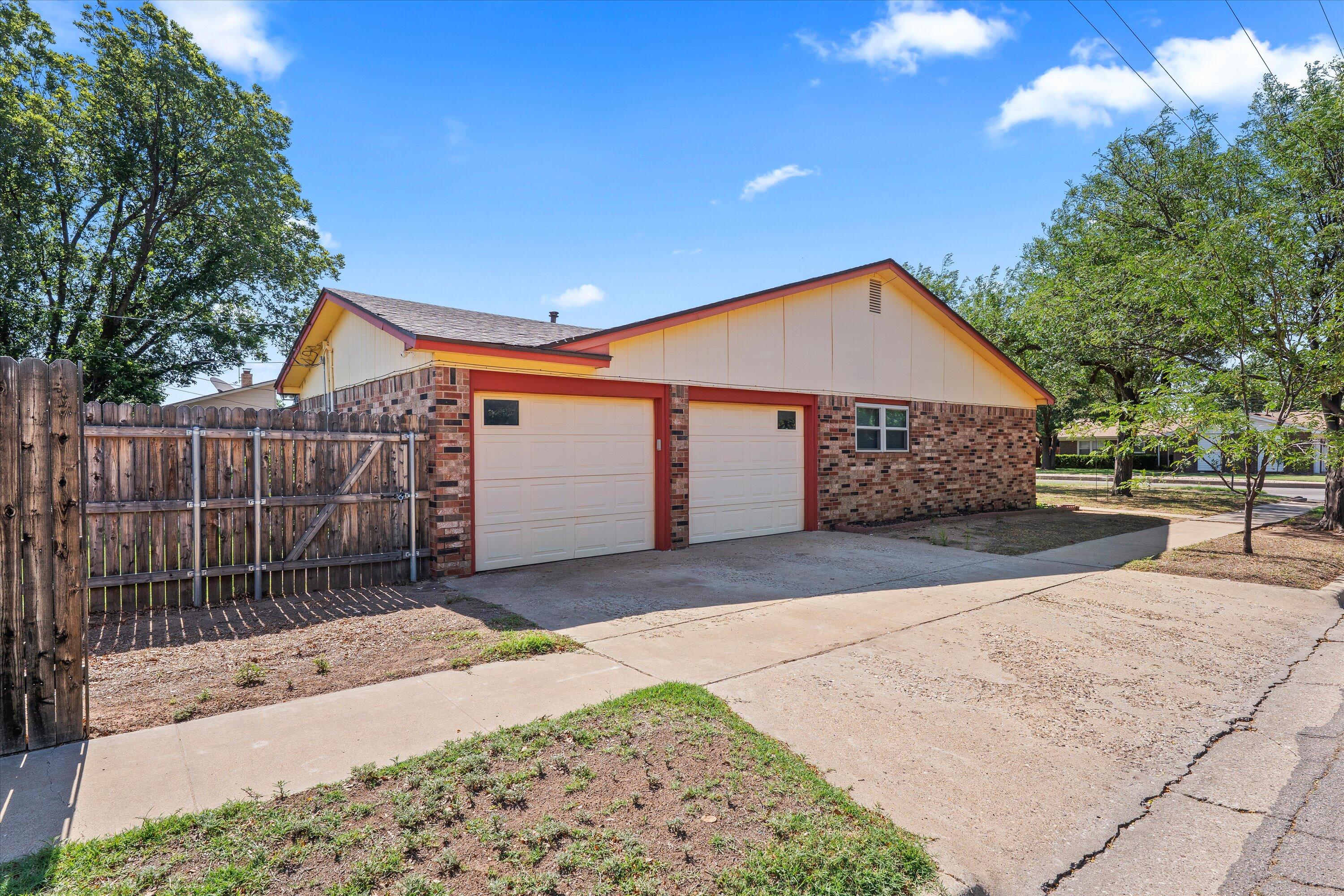 4520 54th Street Lubbock, TX 79414 - Photo 3 of 32 a front view of a house with a yard