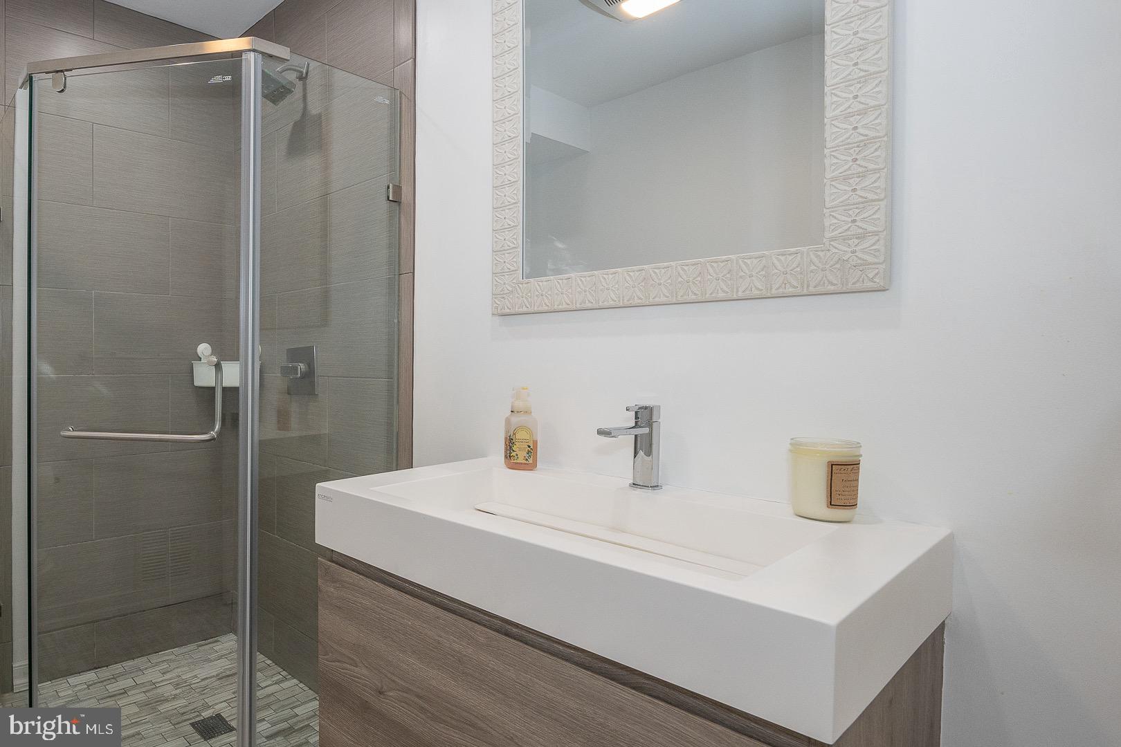 401 North Spring Mill Road Villanova, PA 19085 - Photo 23 of 76 a bathroom with a sink and a mirror