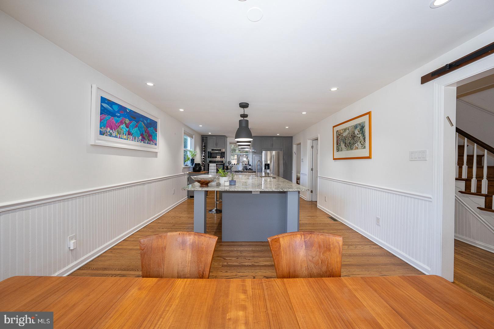 401 North Spring Mill Road Villanova, PA 19085 - Photo 27 of 76 a living room with kitchen island a wooden floor and a kitchen view