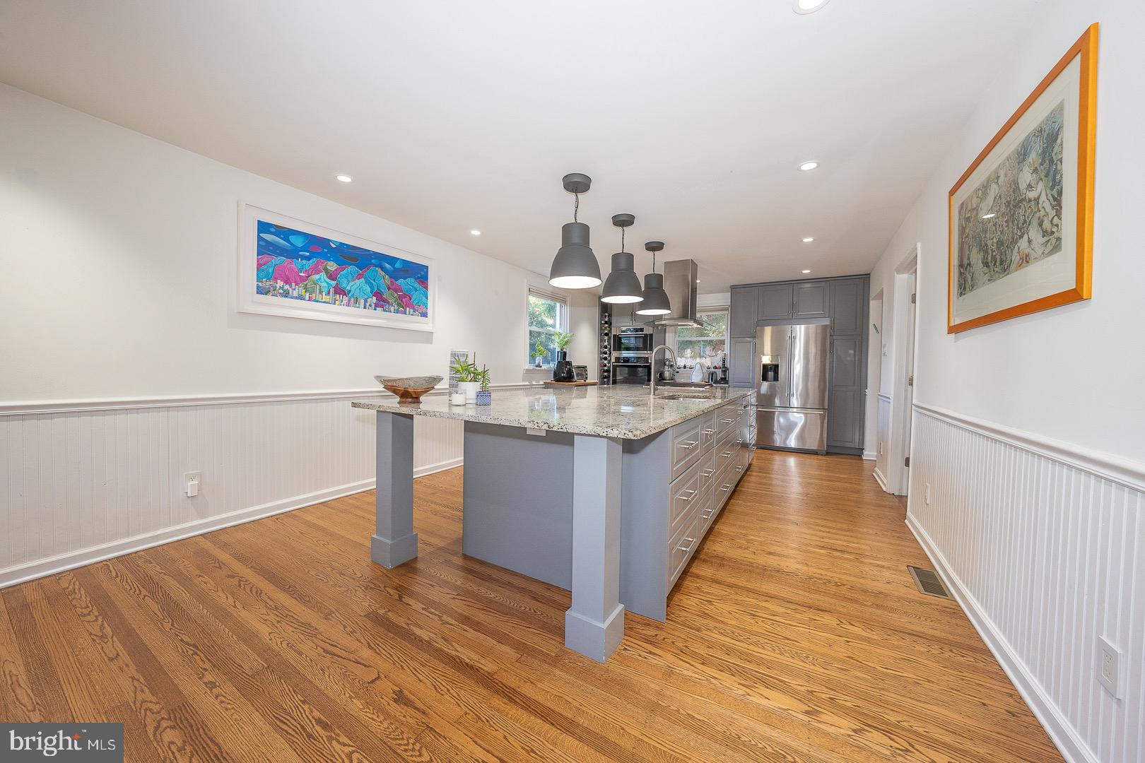 401 North Spring Mill Road Villanova, PA 19085 - Photo 29 of 76 a large room with wooden floor and a view of kitchen