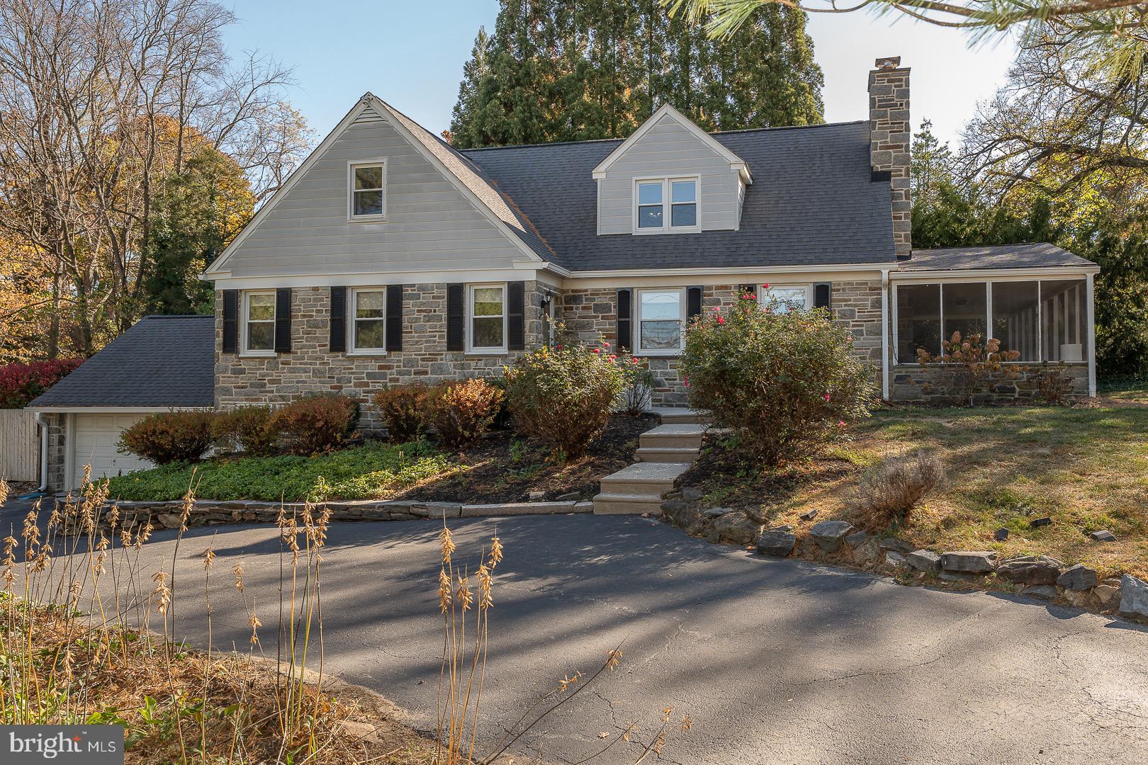 401 North Spring Mill Road Villanova, PA 19085 - Photo 3 of 76 a front view of house with yard and trees around