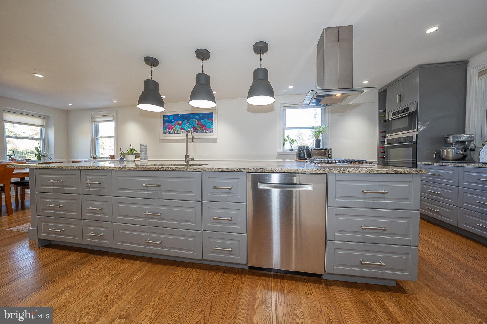 401 North Spring Mill Road Villanova, PA 19085 - Photo 31 of 76 a kitchen with stainless steel appliances granite countertop a sink a stove and a wooden floors