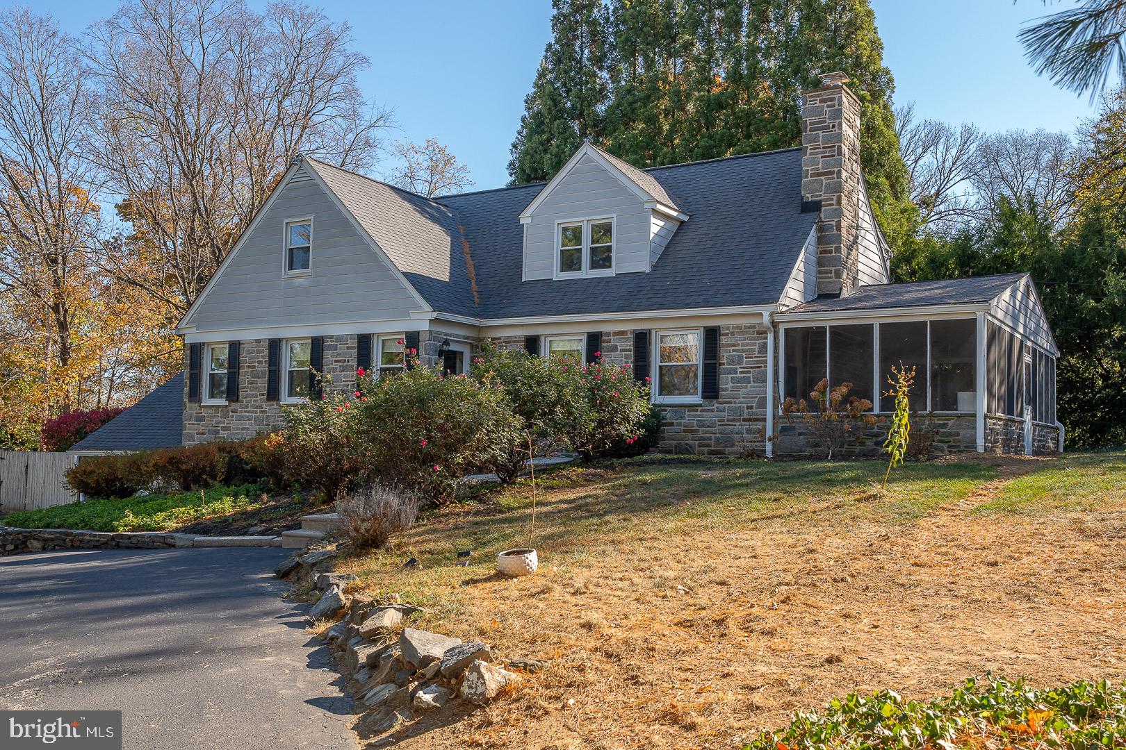 401 North Spring Mill Road Villanova, PA 19085 - Photo 5 of 76 a front view of a house with a garden and porch