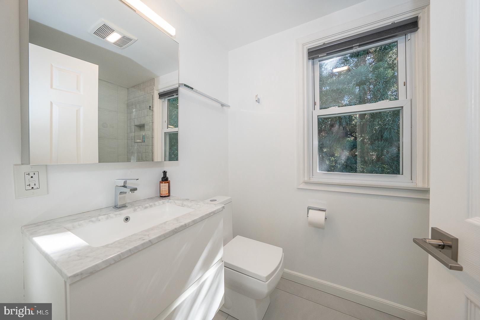 401 North Spring Mill Road Villanova, PA 19085 - Photo 56 of 76 a bathroom with a sink a toilet and a mirror