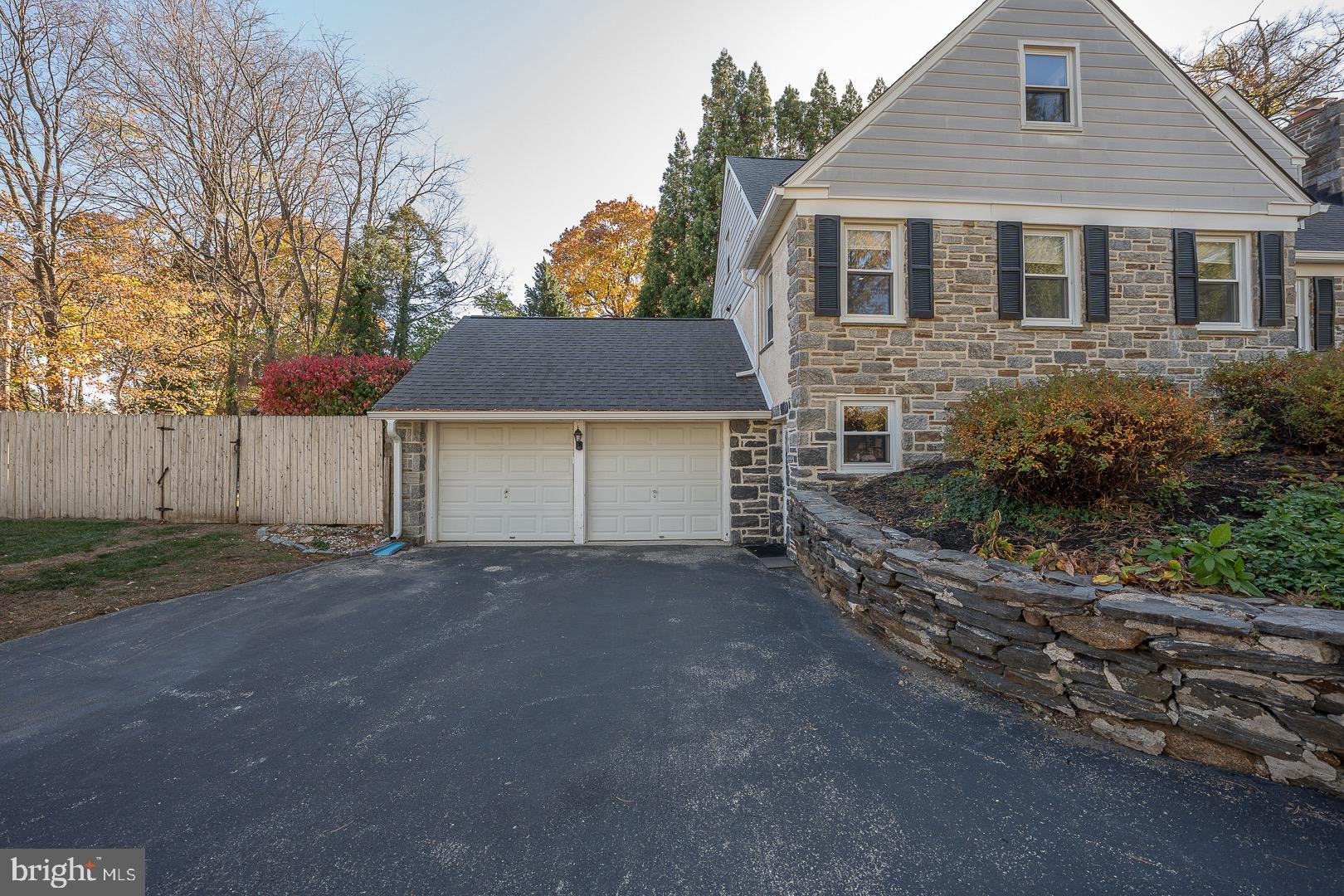 401 North Spring Mill Road Villanova, PA 19085 - Photo 76 of 76 a front view of a house with a yard and garage