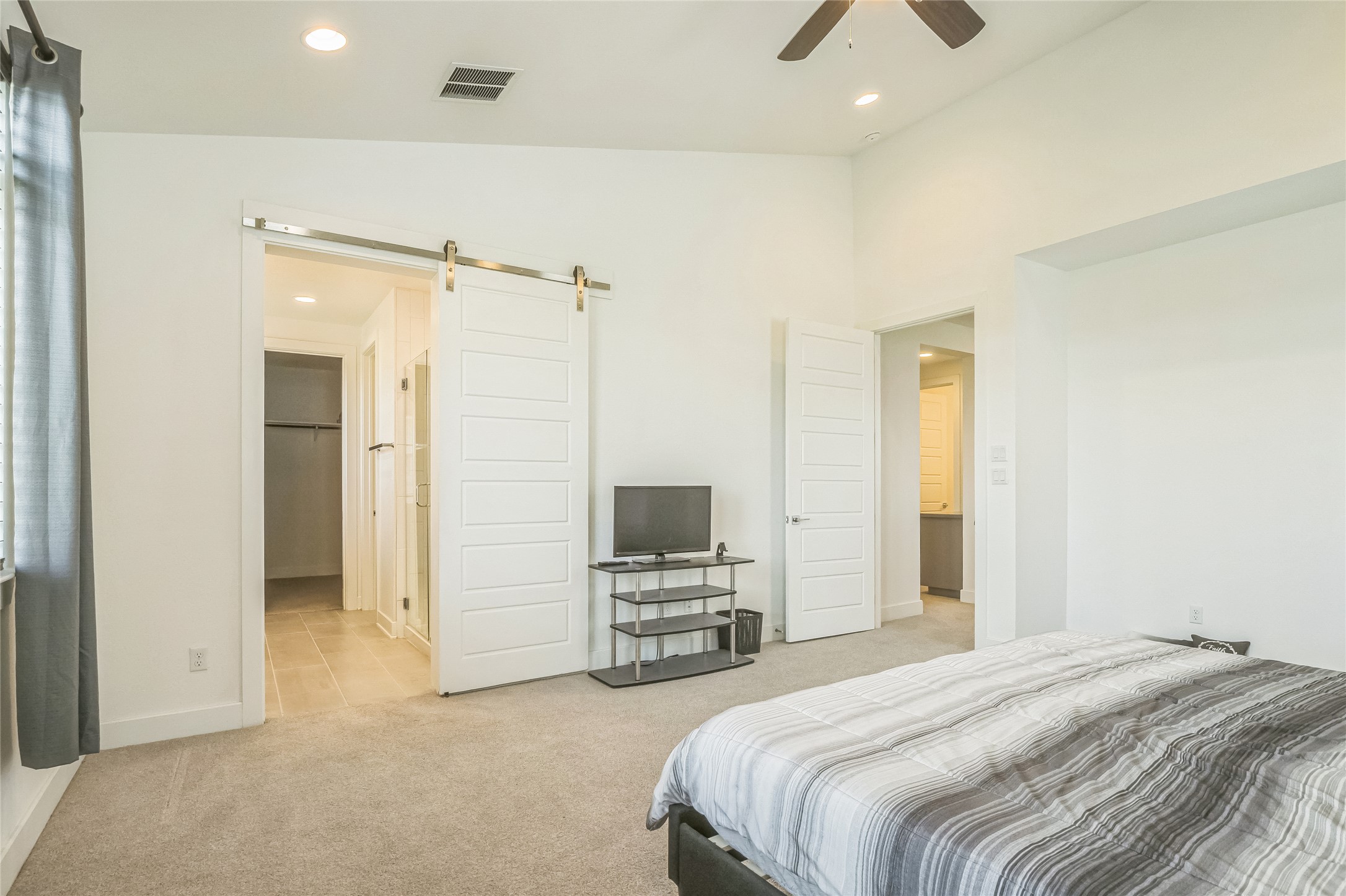 3706 Mesquite Vly Road Georgetown, TX 78628 - Photo 12 of 30 Bedroom with carpet flooring, a barn door, recessed lighting, lofted ceiling, and baseboards