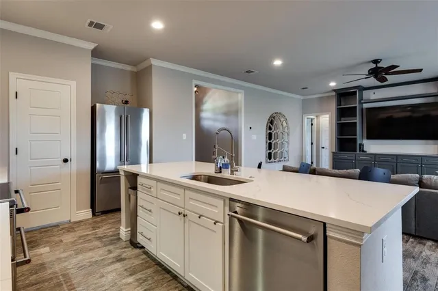 a kitchen with a sink and refrigerator
