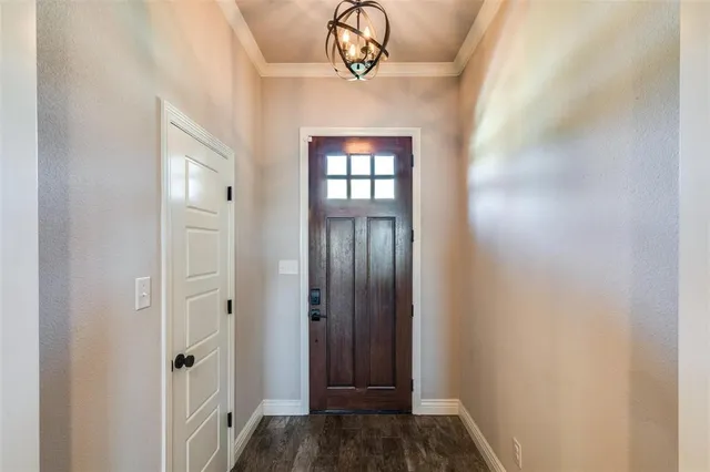 a view of a hallway with wooden floor and closet