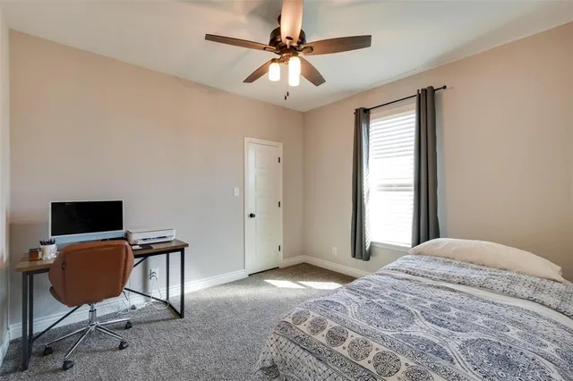 a bedroom with a workspace