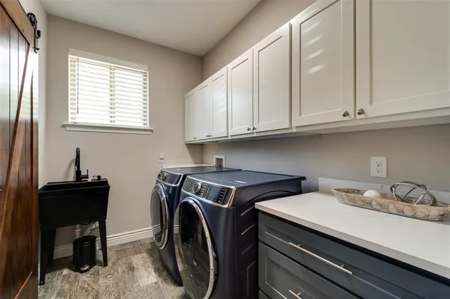a utility room with sink dryer and washer