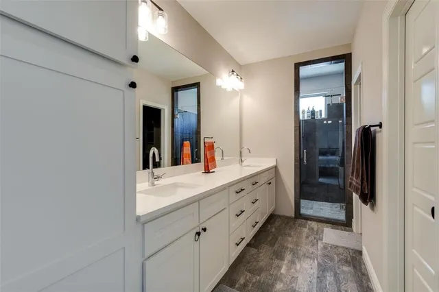 a bathroom with a double vanity sink and a mirror