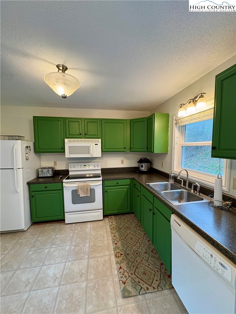 5416 Bamboo Road Boone, NC 28607 - Photo 4 of 35 a kitchen with a stove sink and cabinets