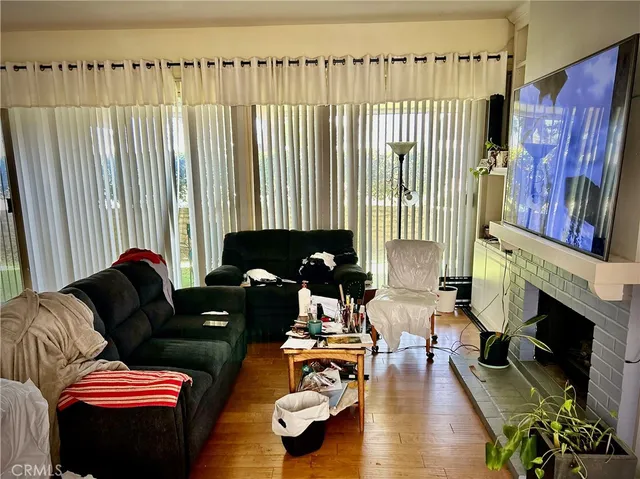 a living room with furniture fireplace and a fireplace
