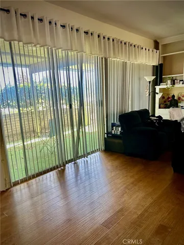 a view of a black gate with wooden floor