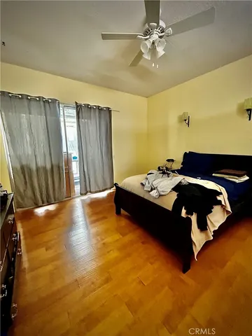 a bedroom with a bed and a table with potted plants