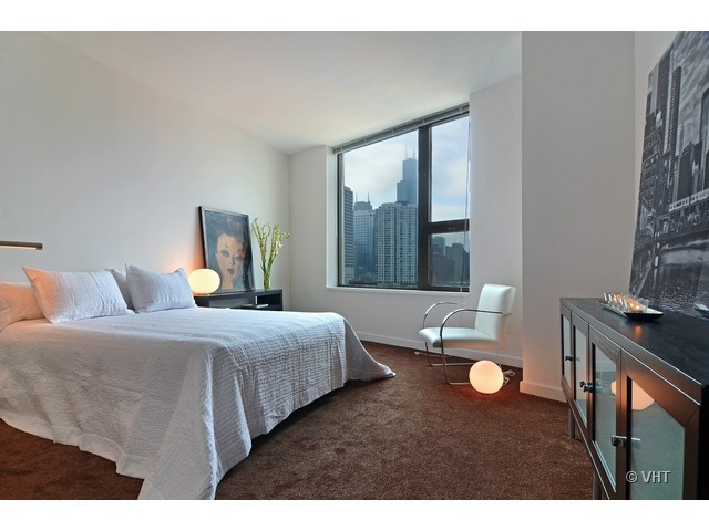 501 North Clinton Street, Unit 1105 Chicago, IL 60654 - Photo 11 of 15 a bedroom with a bed and window