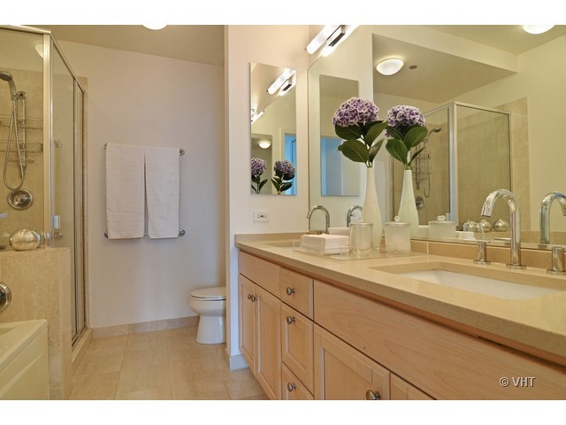 501 North Clinton Street, Unit 1105 Chicago, IL 60654 - Photo 12 of 15 a bathroom with a sink double vanity and a mirror