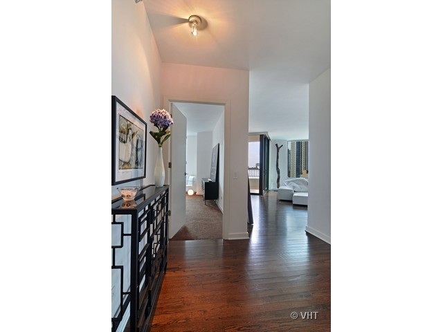 501 North Clinton Street, Unit 1105 Chicago, IL 60654 - Photo 2 of 15 a view of a hallway with couches and dinning table