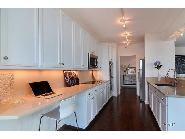 501 North Clinton Street, Unit 1105 Chicago, IL 60654 - Photo 6 of 15 a kitchen view with cabinets and refrigerator