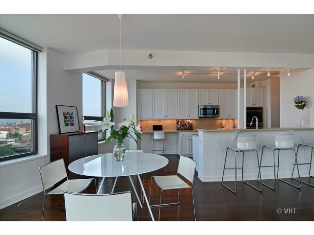 501 North Clinton Street, Unit 1105 Chicago, IL 60654 - Photo 8 of 15 a living room with furniture kitchen view and a large window