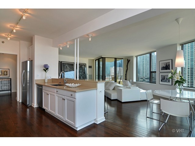 501 North Clinton Street, Unit 1105 Chicago, IL 60654 - Photo 10 of 15 a kitchen with kitchen island counter top space and stainless steel appliances