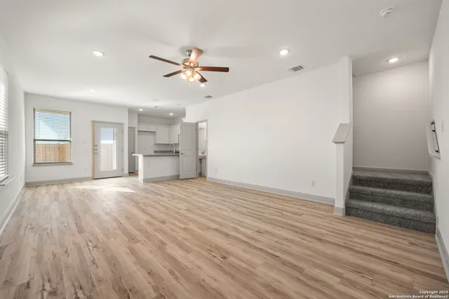 a view of empty room with wooden floor and window